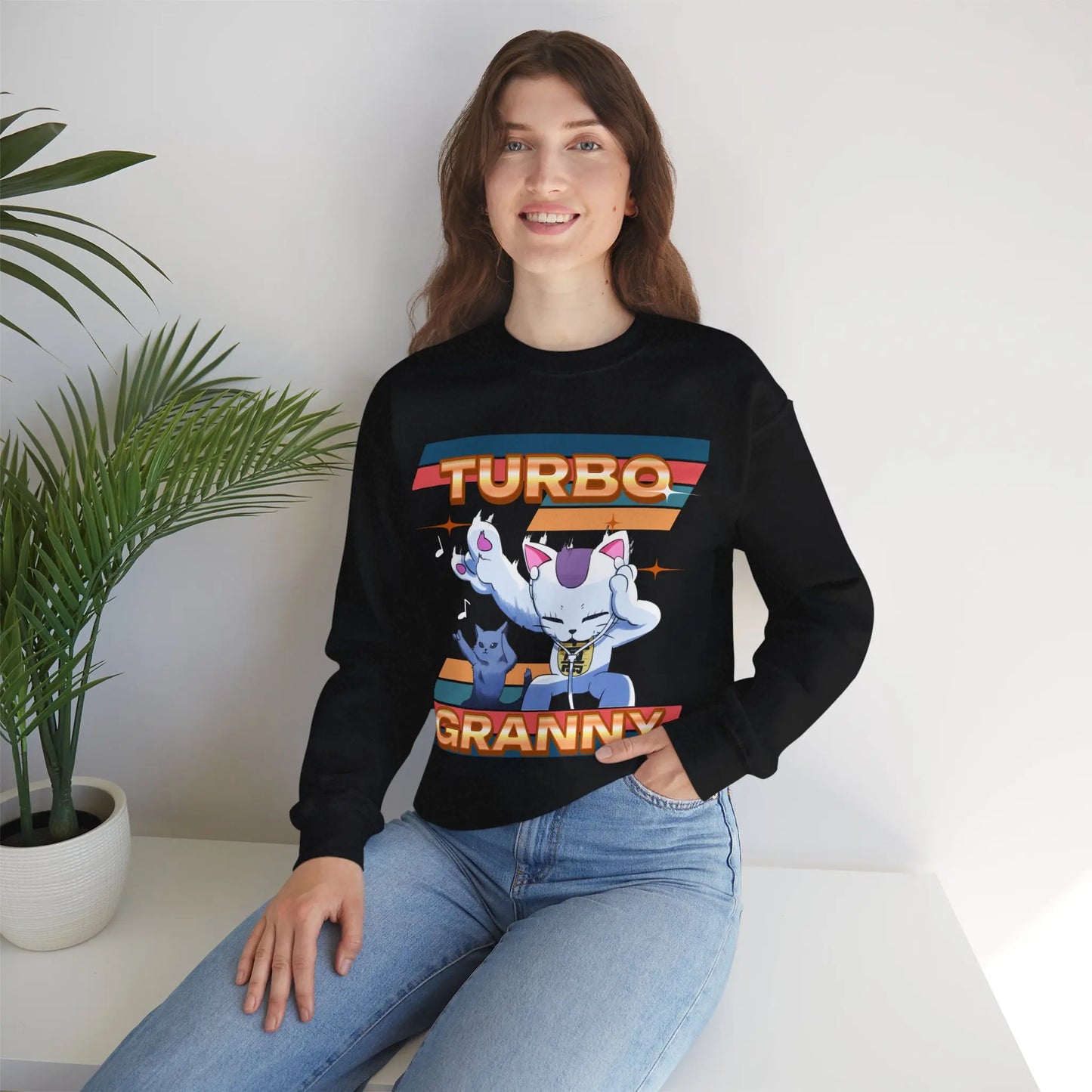 Esta sudadera unisex destaca el gato Mémé TURBO de DAN DA DAN. Diseñado para los fanáticos del anime, combina comodidad y estilo mientras expresa tu amor por esta popular serie.